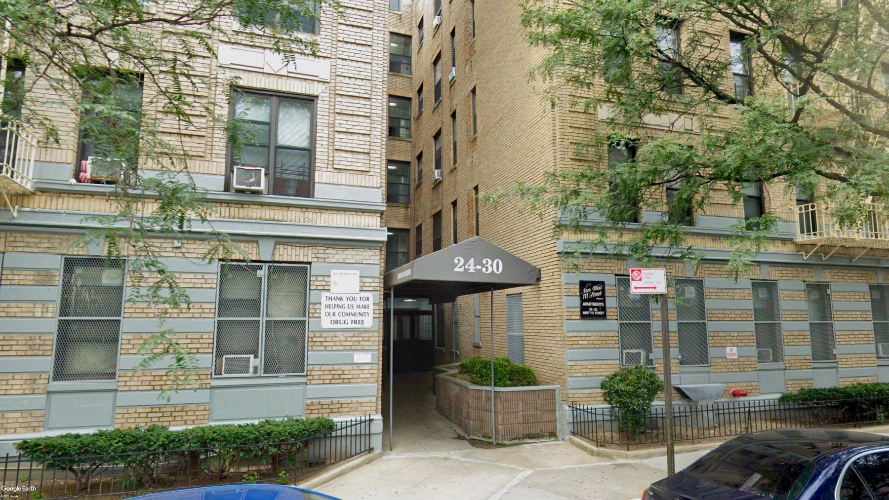 Brick apartment buildings on West 111th Street with a green entrance awning